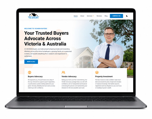 Laptop showing a professional website homepage with hero and navigation.